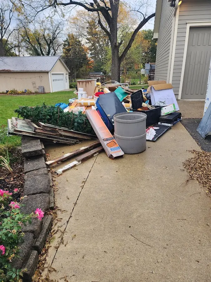 Dumpster being loaded with debris for Commercial Dumpster Rental in Clarendon Hills
